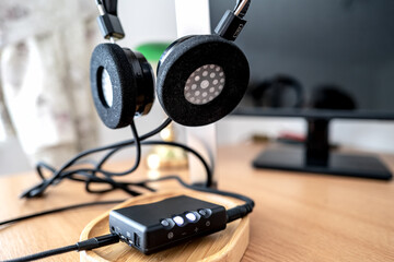 Obraz na płótnie Canvas Shallow focus of a high permanence DAC seen connected via cables to custom headphones.