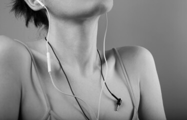 shape of female shoulders close-up with headphones.