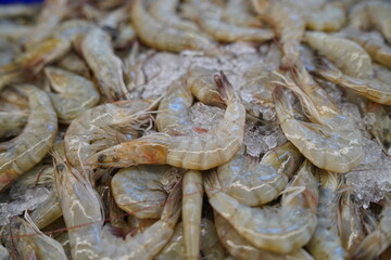 Many fresh raw shrimps close up, heap of prawns on seafood market, gourmet healthy food, sea animal, shrimp pattern, prawn texture.
