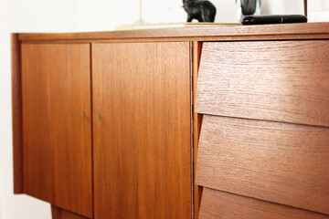 a vintage 60s mid century sideboard cupboard made out of teak wood in denmark standing in the...