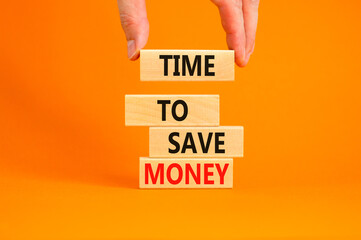 Time to save money symbol. Concept words Time to save money on wooden blocks on a beautiful orange table orange background. Businessman hand. Business, finacial and time to save money concept.
