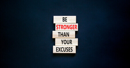 Be stronger symbol. Concept words Be stronger than your excuses on wooden blocks on a beautiful black table black background. Copy space. Business motivational and be stronger concept.