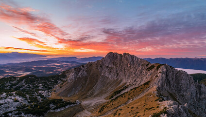 Naklejka na ściany i meble Red and vivid sunrise in the mountains of Julian Alps. 