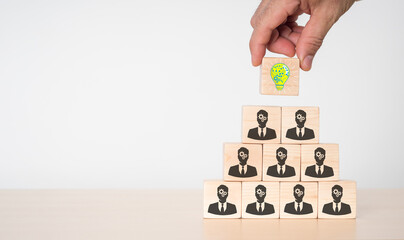 Innovative concept and unique idea Handcrafted wooden cube block with a human head sign and a light bulb icon.
