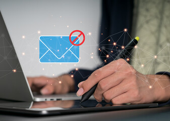 Businesswoman working on laptop computer at home with warning window on screen. Blocking spam...