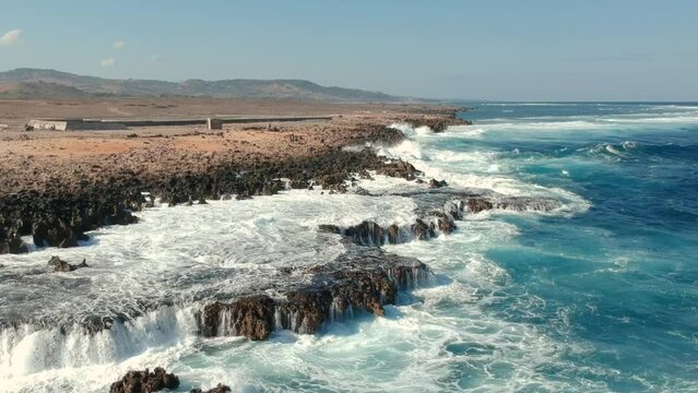 Drone view waves crashing on the beach