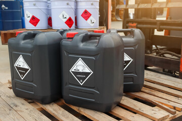 Corrosive chemical symbols on a black chemical tank