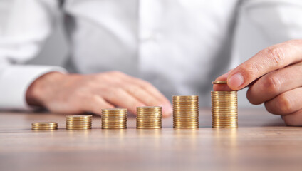 Male hand stacking coins. Saving money. Business. Investment