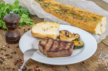 White plate with grilled steak