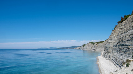 Obraz premium blue sea and sky. Idyllic, picturesque view of the seascape, rocky coast, top view. Good for background. copy space