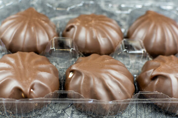 Marshmallow in chocolate frosting close-up.