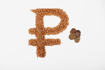 Top view of ruble sign formed of wheat seeds and rouble coins isolated on white. Wheat deficit, crisis and high prices concept