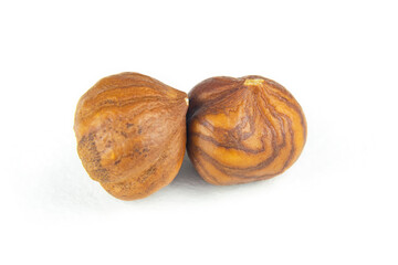 Two nuts close-up. Peeled hazelnuts on a white isolated background.