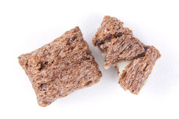 Chocolate corn pillow with milk filling for breakfast on a white isolated background.