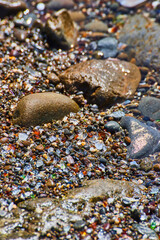 Beach rocks with glass pieces filling in all gaps
