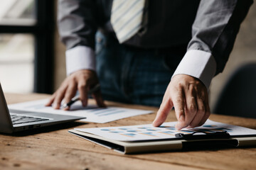 Businessman sits in a private office at his company and is reviewing company financial documents, senior management checking financial information for accuracy. Financial management. copy space