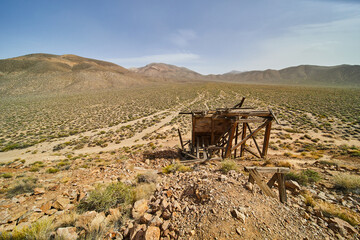 Desert of Death Valley with broken mining equipment by mine