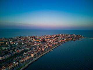 Fototapeta premium View from a height above the town of Pomorie with houses and streets washed by the Black Sea in Bulgaria