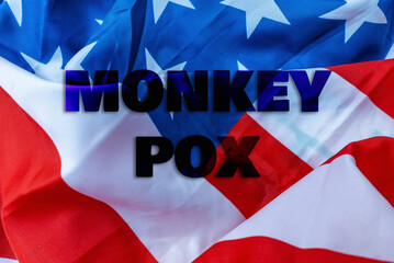 Fototapeta na wymiar Monkeypox outbreak concept.Inscription monkeypox on an american flag.Virus transmitted to humans from animals.The first virus cases of infection in the US.