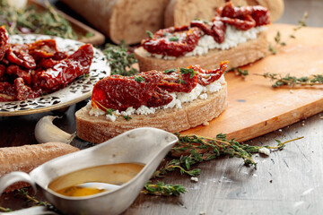 Bruschetta with ricotta, sun-dried tomatoes, and thyme.
