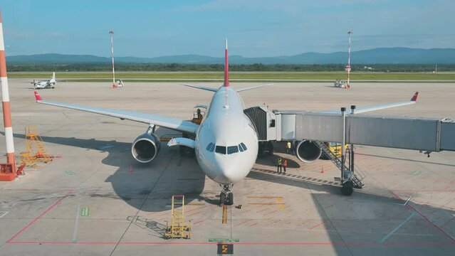 The plane at the airport is waiting for departure at the terminal.