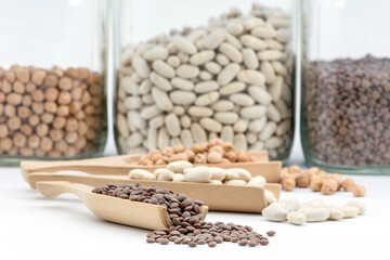 cupboard jars with legumes, palettes with product, all on white background