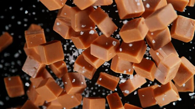 Super Slow Motion Shot of Salted Caramel Explosion Towards Camera Isolated on Black at 1000fps.