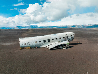 Aerial view of the old crashed plane abandoned on Solheimasandur beach near Vik in Iceland. Landscape with popular tourist attraction in Iceland. Exciting excursion to the sights view in winter