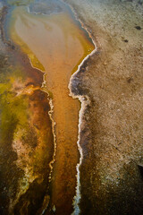 Colorful layers along small acidic creek in Yellowstone