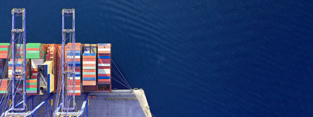 Aerial drone ultra wide top down panoramic photo with copy space of container tanker anchored in...