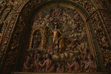 Fototapeta na wymiar Wood carved Baroque marvel, Altar of Souls at Iglesia de San Miguel church, depicting Archangel Michael, master of salvation of souls from purgatory, St. Peter to the left, Jerez de la Frontera, Spain