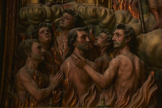 Expressive Baroque painted wooden sculpture of souls in purgatory fire waiting for the salvation of their souls, part of the Altar of Souls at Iglesia de San Miguel church, Jerez de la Frontera, Spain