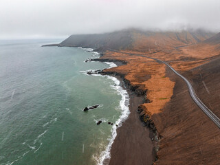Fototapeta premium Aerial Icelandic landscape at Ketubjorg in the evening dusk. Cloudy coastline, ocean and grassland. Peninsula Skagi