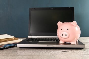 Piggy bank with laptop