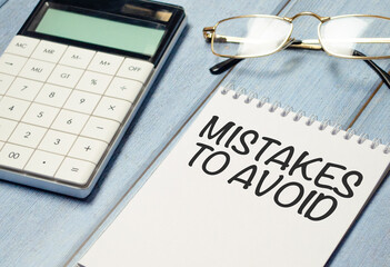 text mistakes to avoid on notebook with glasses and calculator