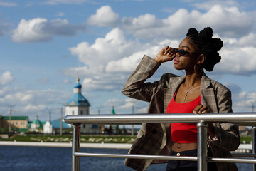 Fototapeta na wymiar african girl on the background of Cheboksary dam