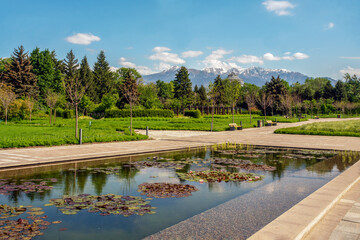 Fototapeta premium Idyllic view in Botanical garden of Almaty with panorama of Mountains - Tien Shan ( Urumqi)