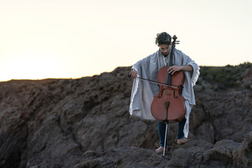 young man playing cello