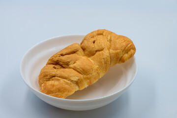 Selective focused Chocolate croissant on isolated white background macro close up shot. .Croissant isolated on a white background on a bowl.