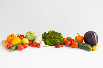Panorama of fresh vegetables and fruits on white background.