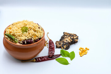 Selective focused ,Tamarind Rice/  Puliyodharai / Puliyogare - Tangy and spicy South Indian rice dish as break fast , Lunch or dinner isolated in white background. Tamarind as main ingredient. 