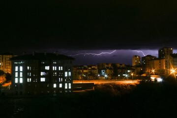 The lights of the city and lightning