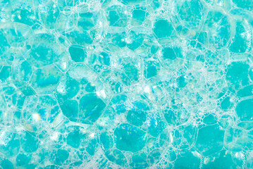 Soap foam. Background of dusty foam with bubbles of blue color for an inscription. Soap sud with copy-space