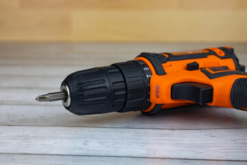 Cordless combo drill for used as normal drill, impact drill on wooden background. Selective focus