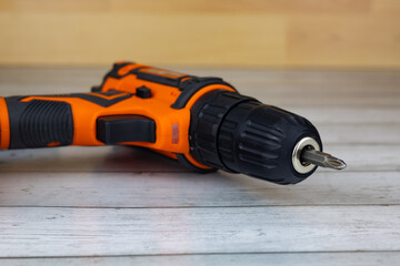 Cordless combo drill for used as normal drill, impact drill on wooden background. Selective focus