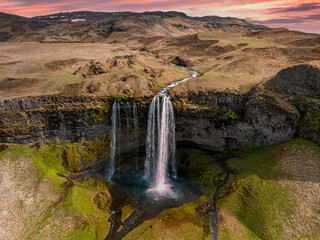 Aerial view of the Seljalandsfoss - located in the South Region in Iceland right by Route 1. Visitors can walk behind it into a small cave. Most popular waterfall in Iceland.