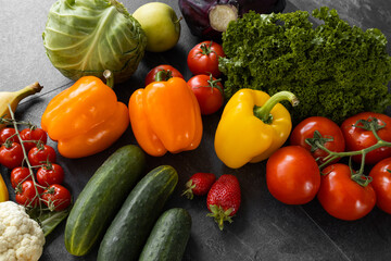 Fresh vegetables and fruits on a black background. Organic food. Top view. Free copy space.