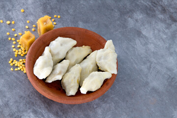 Selective focused Kozhukatta Pidi in mud plate Indian Kerala , Tamilnadu tea time snack steamed food sweet modak rice dumpling for ganesha chathurthi, Diwali, Navratri Dussehra