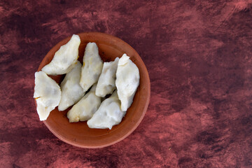Selective focused Kozhukatta Pidi in mud plate Indian Kerala , Tamilnadu tea time snack steamed food sweet modak rice dumpling for ganesha chathurthi, Diwali, Navratri Dussehra
