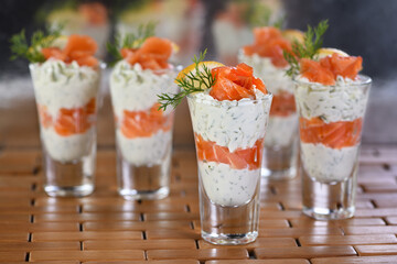   Verrines  from soft cheese cream and salmon, dill sprig and lemon slice. Aperitif appetizer.